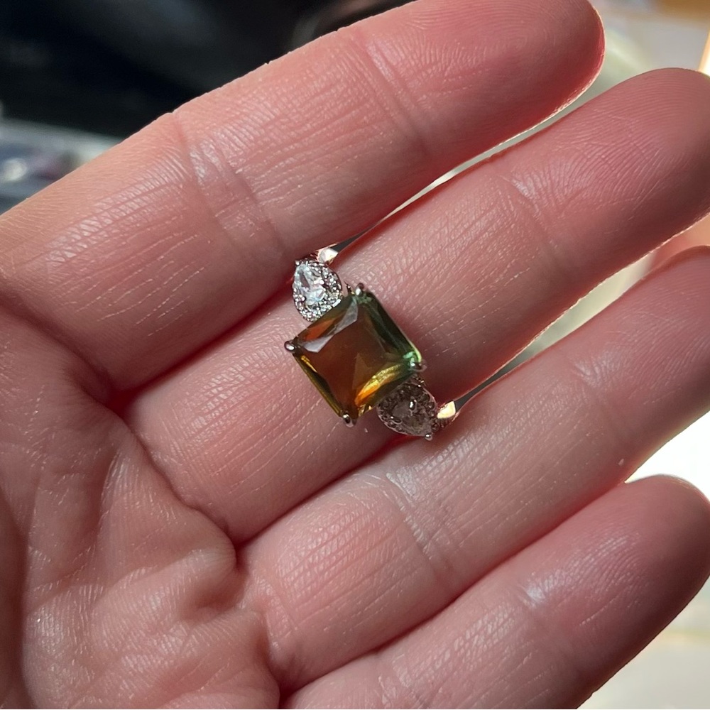 Size 9. Lab created lime bi color peridot on rhodium plating. SRP $136